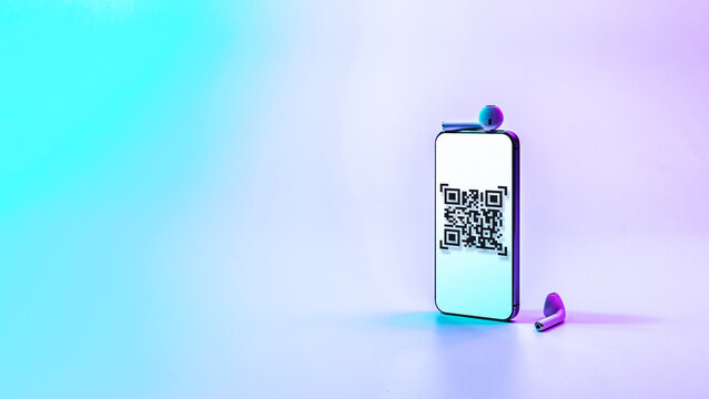 Qr code payment. Digital mobile smart phone with qr code scanner on smartphone screen for pay, scan barcode technology on neon background. Online shopping, cashless society technology concept.
