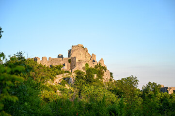 Old castle on the hill. Medieval fortification at sunset. Walls and forts. 