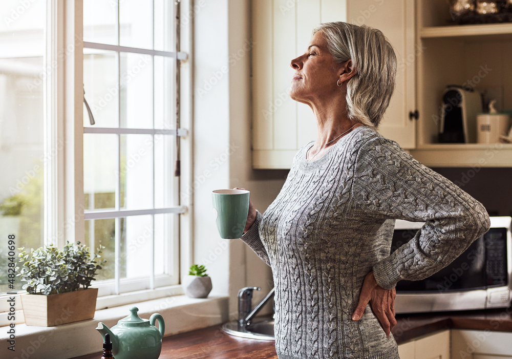 Poster Already feeling better. Cropped shot of a relaxed senior woman preparing a cup of tea with CBD oil inside of it at home during the day.