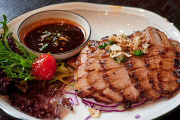 sliced pok neck got grilled and served with spicy dip-sauce.