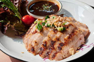 sliced pok neck got grilled and served with spicy dip-sauce.