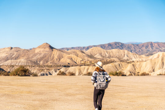 A young woman walking in the Las Salinas ravine on a trek in the Tabernas desert, Almer&iacute;a province, Andalusia