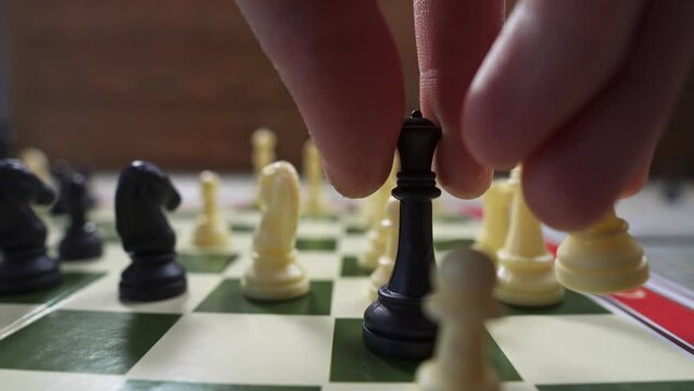 Chess board with pieces. Player drops the white king resigning himself to defeat. The concept of strategy in business