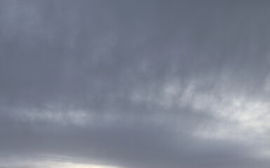 Photo of clouds and fog floating in the air with gray and white alternating Gives it a dull,...