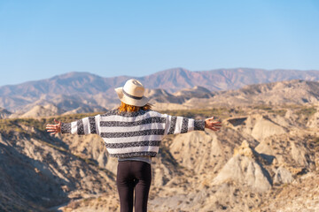 A young hiker enjoying freedom in the desert canyon of Tabernas, Almería province, Andalusia. On a trek in the Rambla del Infierno - obrazy, fototapety, plakaty