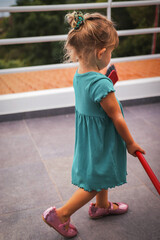 little girl in a adress playing on the terrace of madeira portugal and having fun