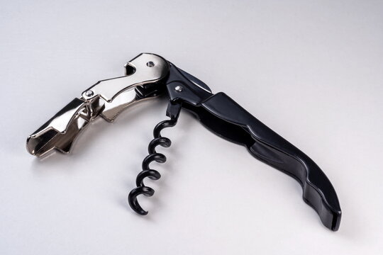 Metal black corkscrew on white background