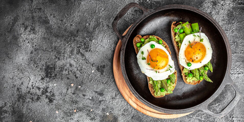 Grilled Toast witch Asparagus, Poached egg, bacon jamon, ham, banner, menu, recipe place for text, top view Food recipe background. Close up