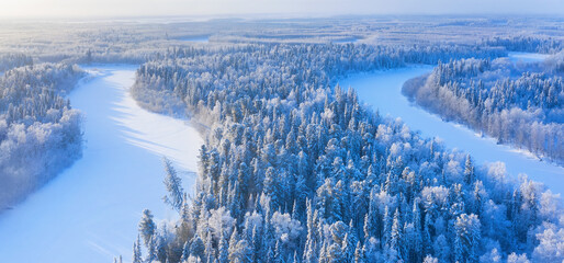 Winter landscape. Aerial view. Landscape with winding river and snowy forest in Western Siberia. Agan River, Yugra