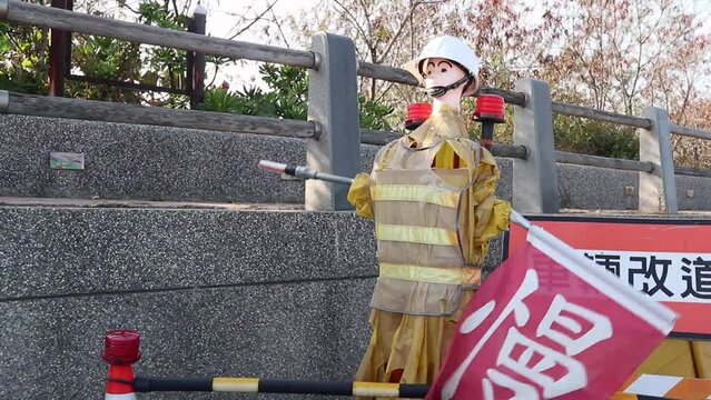 dummy is working for under construction road to warn people watching out and slowing down in Taiwan