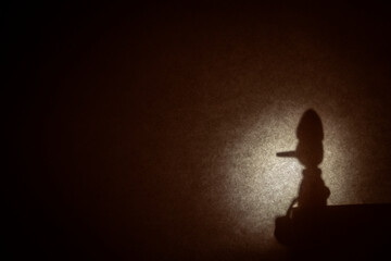 Silhouette of Pinocchio sitting in profile with a moon behind and writing space.