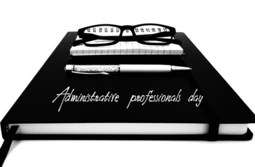 Agenda, notebook, pen and reading glasses on white background,  administrative professionals day.