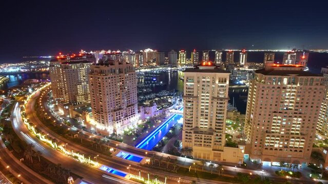 timelapse aerial view of The Pearl Qatar, an artificial island in Doha, Qatar at night
