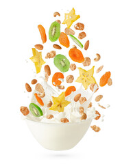 Cereal corn flakes with fruits and nuts falling into the bowl with splashing milk. Isolated on...