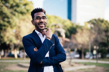 Portrait of smiling businessman with glasses on the street