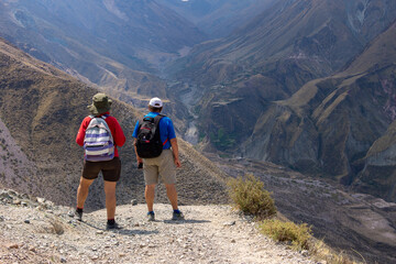 Elderly couple trekking through mountains in northern Argentina.