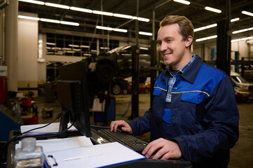 A technician, garage mechanic typing on keyboard, making checklist for repairing cars, conducting diagnostic check of a car during regular warranty maintenance in auto service