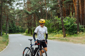 Male cyclist spends time actively cycling in the woods outdoors. Active recreation on a bicycle.