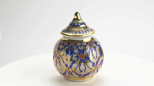 Rotation of famous beautiful souvenir Benjarong cup porcelain of Thailand. Benjarong is Thai porcelain, the pattern design in five colors.