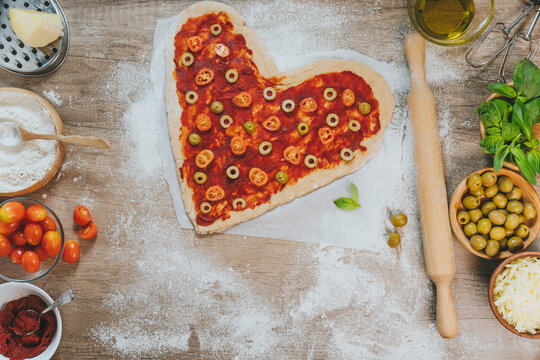 Heart shape homemade pizza on the table