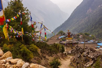 Papier Peint photo Manaslu Road with rocky fences to the stupa and further along the path in the Himalayas