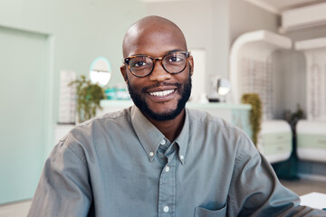 Good eye health makes me happy. Portrait of a confident young man working in an optometrists office.
