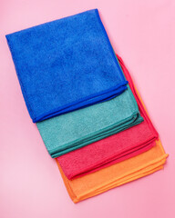 Colored Microfiber Napkins for Cleaning a Top View on a Pink Background Horizontal
