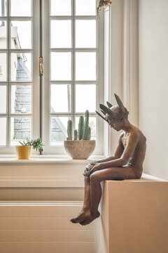 Sculpture on cabinet near window