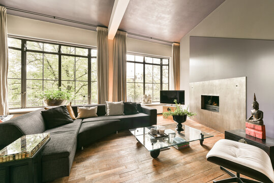 Modern living room with fireplace and big windows