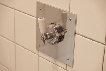 Shower handle on tiled wall