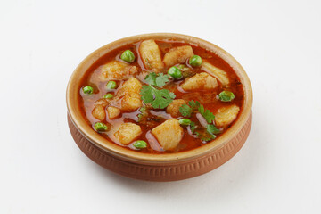 Aloo Mutter , Indian curry Potato and Peas immersed in an Onion Tomato Gravy and garnished with coriander leaves.