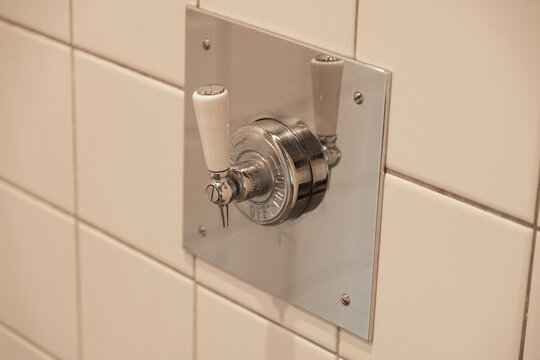 Shower handle on tiled wall