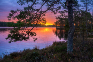 A very colorful sunset on the northern lake. Autumnal nature in Karelia to Russia