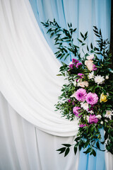Wedding decorations in luxury ceremony. Arch decorated with flowers and greens, greenery.  wedding decor in the backyard banquet area.