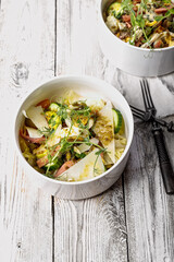 Delicious fish salad with lightly salted salmon, egg, cheese, fresh herbs and spicy mustard sauce. Prepared in the home kitchen. Delicious and healthy seafood. Mediterranean Kitchen. Vertical shot