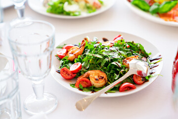 salad of arugula lettuce, tomatoes and shrimp.