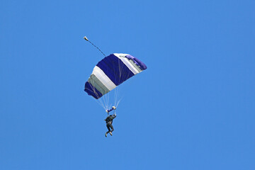 Skydiver in a blue sky	