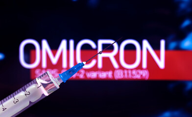 Omicron coronavirus variant. World epidemic background with syringe close-up, concept of vaccination