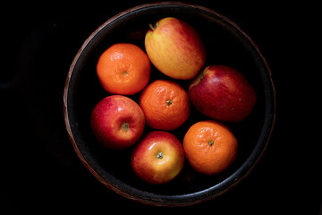 A bowl of apples and tangerines
