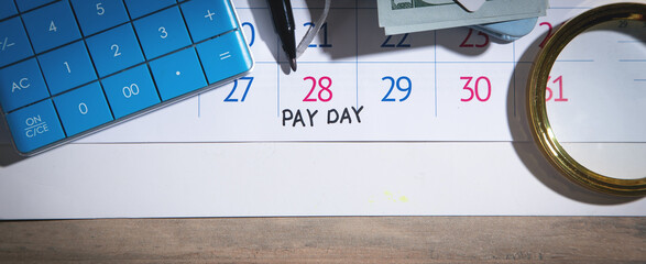 Pay Day of the month. Marker, calculator  on calendar