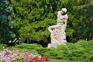 Statue in the park - green trees around