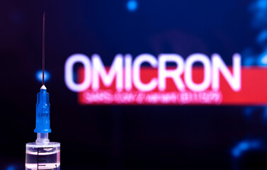 Coronavirus Omicron variant background. Syringe needle close-up, world epidemic and vaccination...