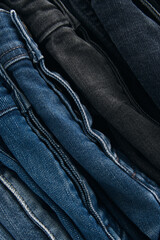 Stack of Various Shades Of Blue Jeans On White Background Denim jeans texture. Denim background texture for design. Canvas denim texture. Blue denim that can be used as background.