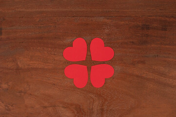 Four heart isolated in a wooden background