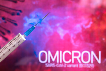 Coronavirus Omicron variant background. Syringe needle close-up, world epidemic and vaccination...