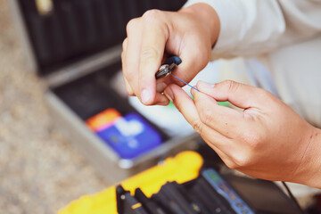 Fiber optic splice procedure Technician Fiberoptic Fusion Splicing. Worker connecting for Cable Internet signal and Wire connection with Fiber Optic Fusion Splicing machine.