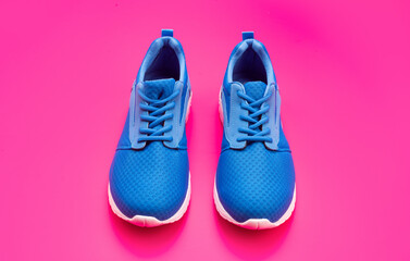 sporty blue sneakers. shoes on pink background. shoe store. shopping concept.