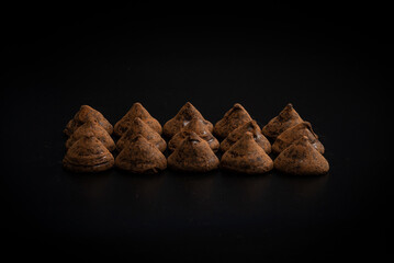 Chocolate truffles on a black background.