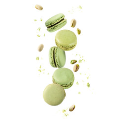 Flying green sweet pistachio macarons macaroons with crumbs and nuts isolated on white
