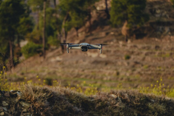 drone flying over a field, flying in the woods